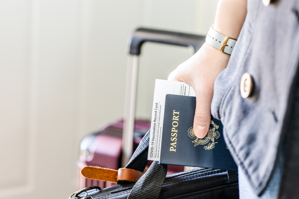 Business Traveler with US citizenship identification, vaccinated certified passport and personal belonging ready for travel in new normal.