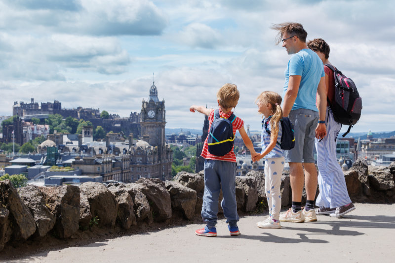Family with kids enjoys scenic city of Edinburgh skyline view
